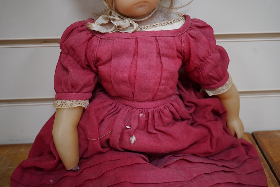 A 19th century poured wax shoulder doll, paperweight eyes and jointed limbs, 60cm. Condition - some damage